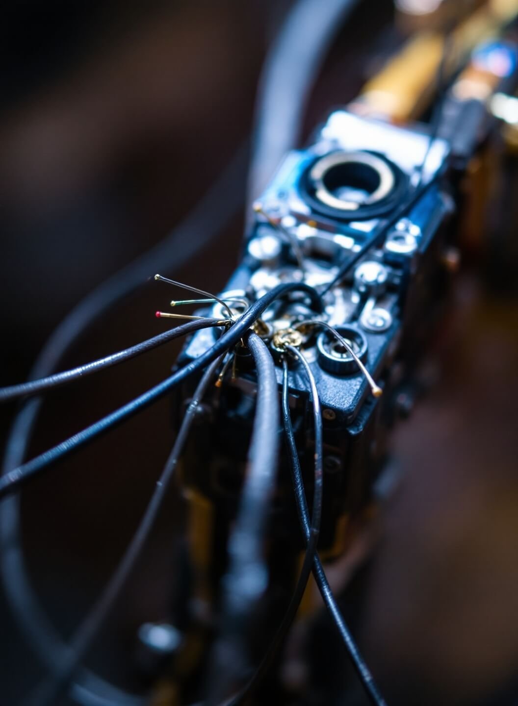 Extreme close-up of proper wire securing technique highlighting intricate construction details under studio lighting, shot with macro lens on tripod